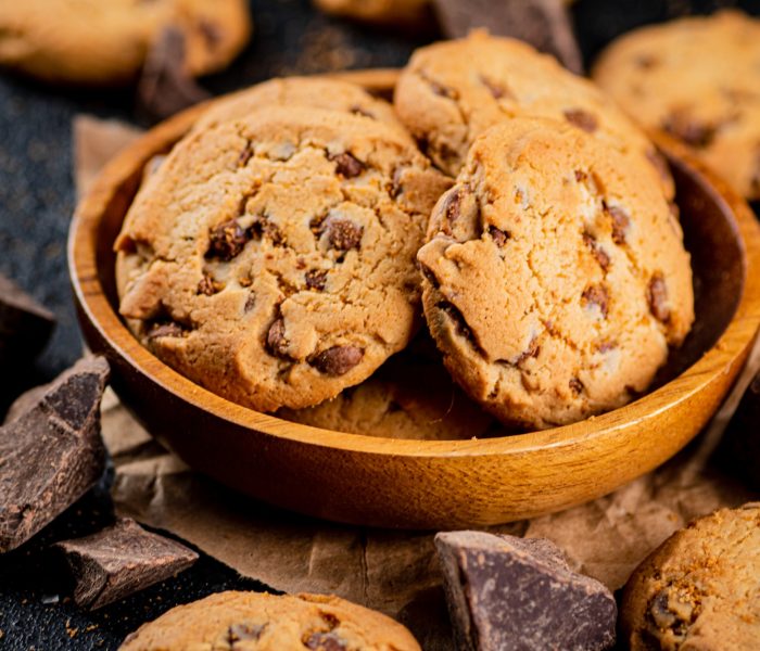 Delicious cookies with pieces of milk chocolate on a plate.