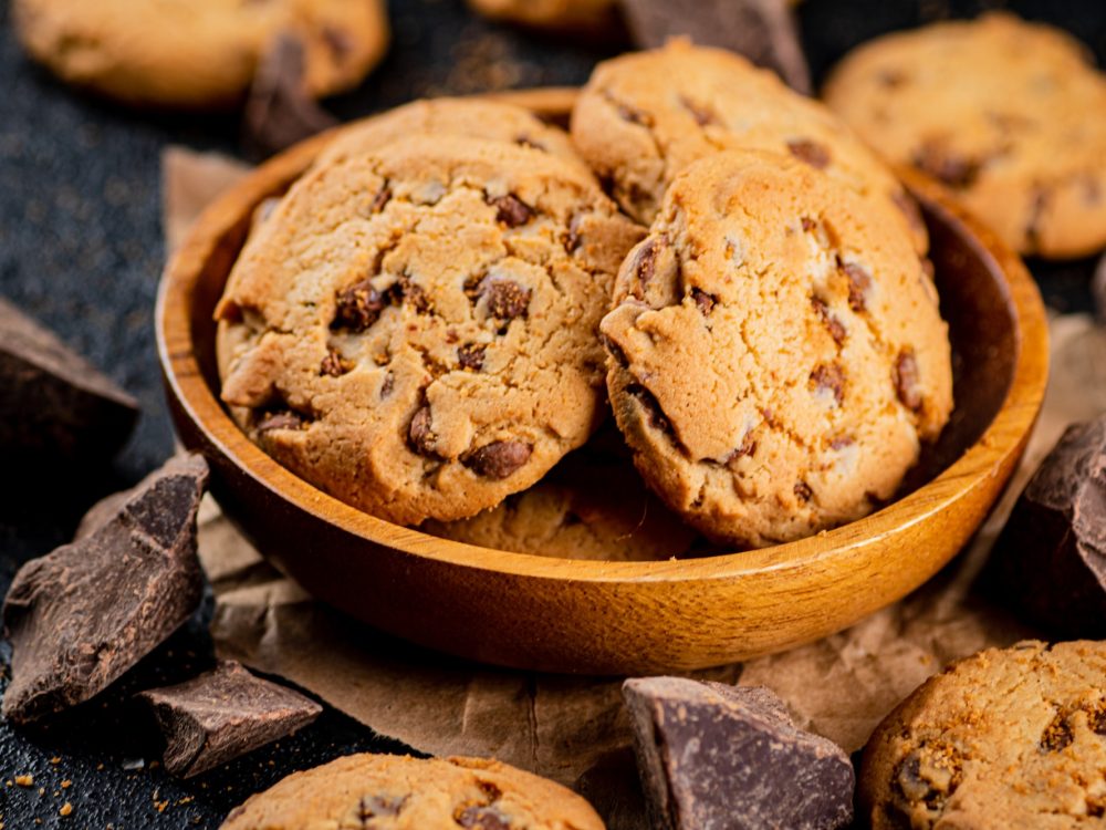 Delicious cookies with pieces of milk chocolate on a plate.